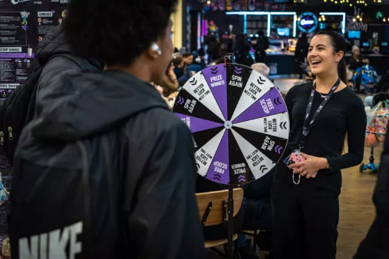 Smiley Cream worker with spin the wheel with customer.